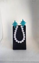 Load image into Gallery viewer, Atomic Star Cardigan Clips in Glow in the Dark Light Blue